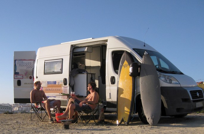 Campervan parked at sunset with barbecue